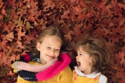 sisters laughing in leaves
