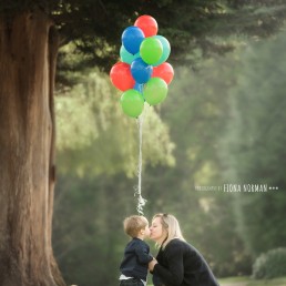mother with a son and lots of balloons