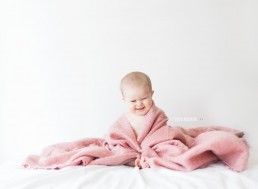 baby in pink blanket