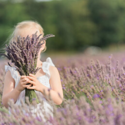 girl hiding behind lavender