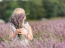 girl hiding behind lavender