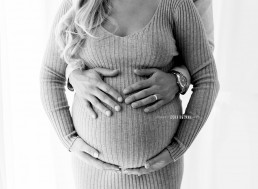 maternity photo with hands on stomach
