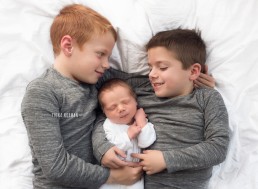 newborn baby with brothers