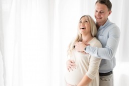 pregnant lady laughing with husband