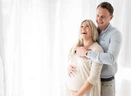 pregnant lady laughing with husband