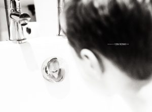 boy looking at his reflection in bath