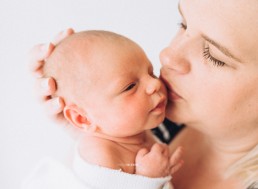 mother kissing baby