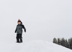 child on snowy mountain in lapland