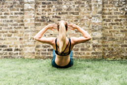 GIRL DOING SIT UPS AGAINST A WALL