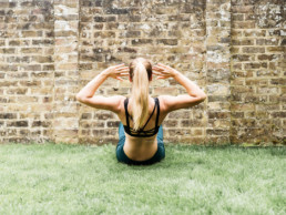 GIRL DOING SIT UPS AGAINST A WALL