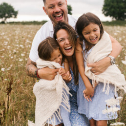 Family photo hugging in field