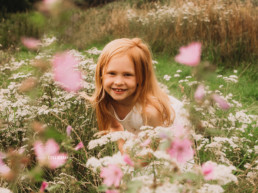 girl hiding in flowers